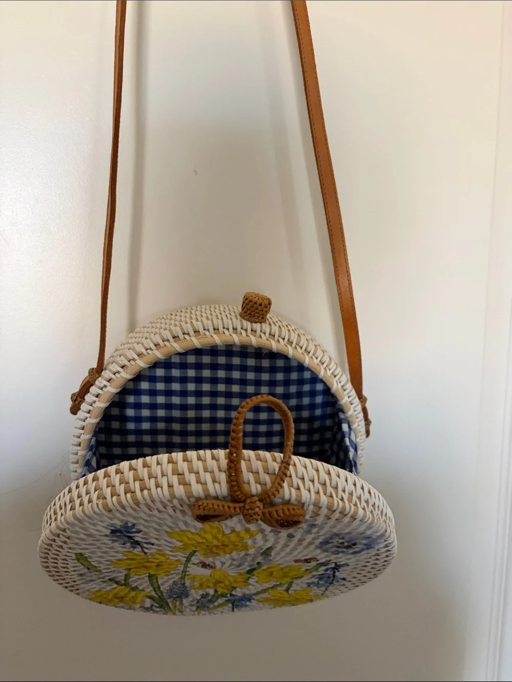 Round Straw Crossbody Bag with Yellow Floral Embroidery. 8x8 in., 24in strap